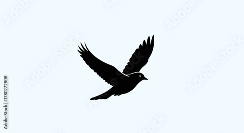 Graceful black bird silhouette soaring with wings spread wide, symbolizing freedom, hope, and new beginnings in a clean, modern design.