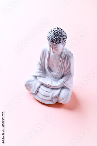 Meditating Buddha Statue on bright background. Soft focus. Copy space	