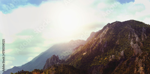 Big boulders on the mountain and there is a beautiful sky.