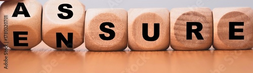 Foto Wooden blocks spell out the word assure
