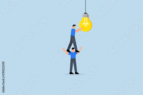 Partnership to success together, Entrepreneur assists colleague in activating lightbulb.