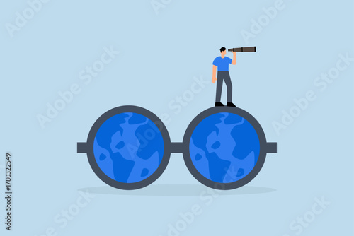 world business vision, entrepreneur gazes through binoculars while wearing glasses featuring globe map.
