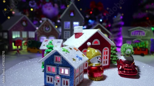 In front of the big Christmas town, a small town with colorful houses is spinning