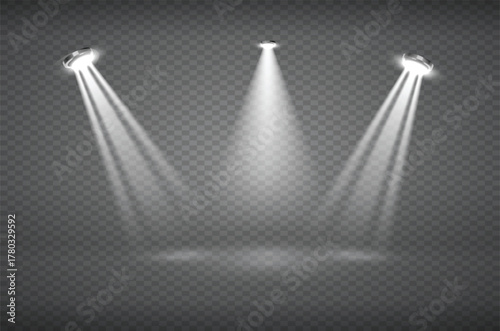 Three white spotlights cast beams of light downwards onto a dark surface, creating a dramatic stage effect.
