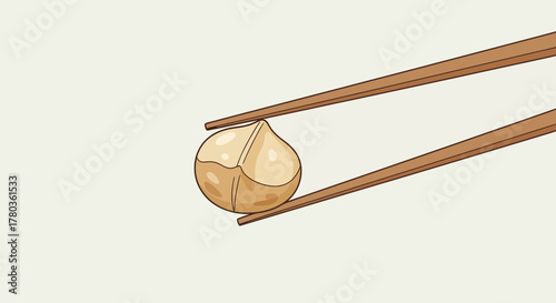 Chopsticks Carefully Holding a Roasted Hazelnut on a Cream Backdrop for Food Lovers