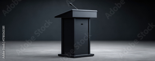 Serious black podium with microphone awaits speech on dark stage for presentation