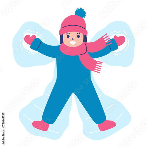 Smiling child in winter clothes making a snow angel