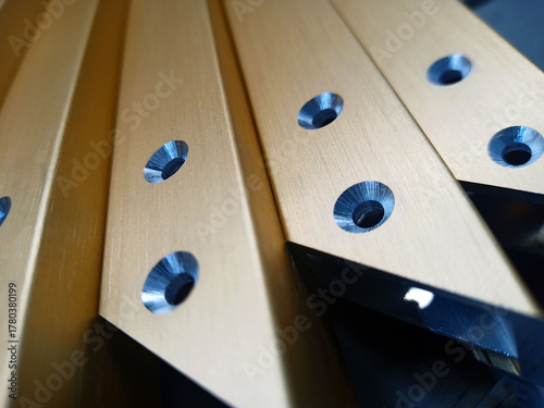 Details of furniture facades with an aluminum frame with countersunk holes. gold color
