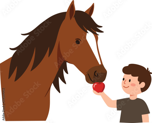 A boy feeds a brown horse an apple.