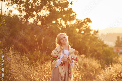 girl on the field in the evening. girl of Slavic appearance in a beautiful place