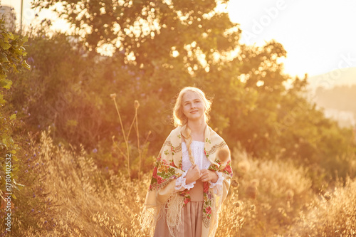 girl on the field in the evening. girl of Slavic appearance in a beautiful place