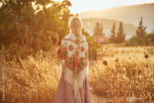 girl on the field in the evening. girl of Slavic appearance in a beautiful place