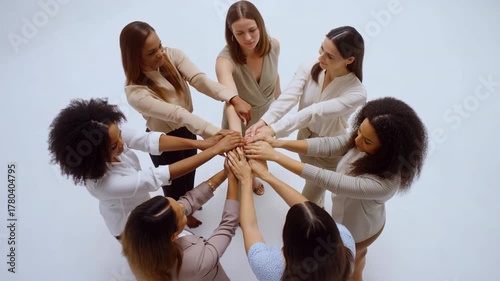 Diverse women team stacking hands in unity