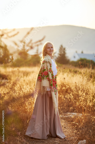 girl on the field in the evening. girl of Slavic appearance in a beautiful place