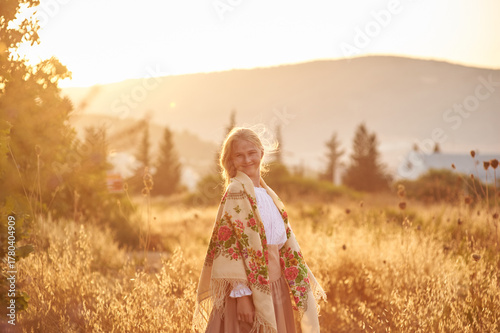 girl on the field in the evening. girl of Slavic appearance in a beautiful place