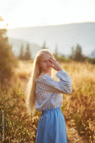 girl on the field in the evening. girl of Slavic appearance in a beautiful place