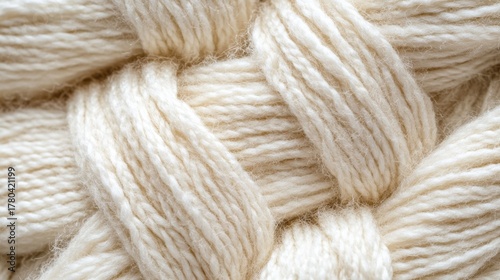 Soft cream wool yarn close-up showing warm cozy texture and natural fibers in detailed pattern