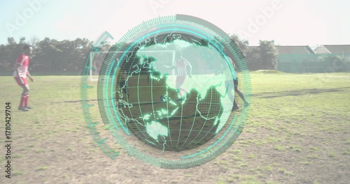 Running eight soccer players in soccer kit across grass field, with globe overlay and soccer ball