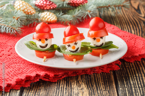 Christmas appetizer snowman caprese on skewers close-up in a plate on the table. Horizontal