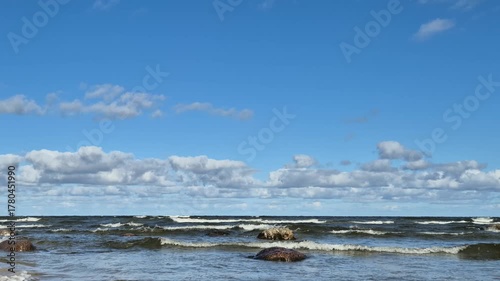 4K footage of gentle sea waves rolling toward the Baltic coast. Bright daylight, blue sky, and calming natural sound of ocean.