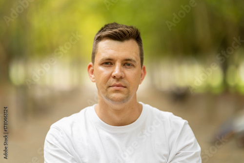 Young man with serious expression looking directly at camera