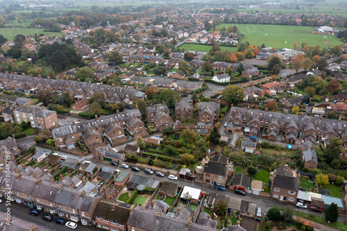 Aerial drone photo of the market town of Thirsk in North Yorkshire, England showing rows of victorian terrace houses and homes on a gloomy dark bad weather rainy day in the winter time