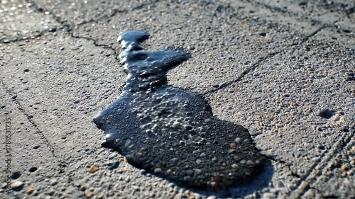 Dark Viscous Liquid Spreading and Bubbling on Cracked Concrete Surface
