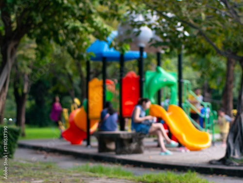 Wallpaper Mural Blurred out of focus colorful children playground with slides and climbing equipment in public park surrounded by trees Torontodigital.ca