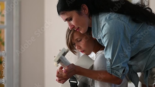 A mother gently guides her child during a creative project, showcasing an engaging moment filled with connection and discovery in a well-lit, inviting environment.