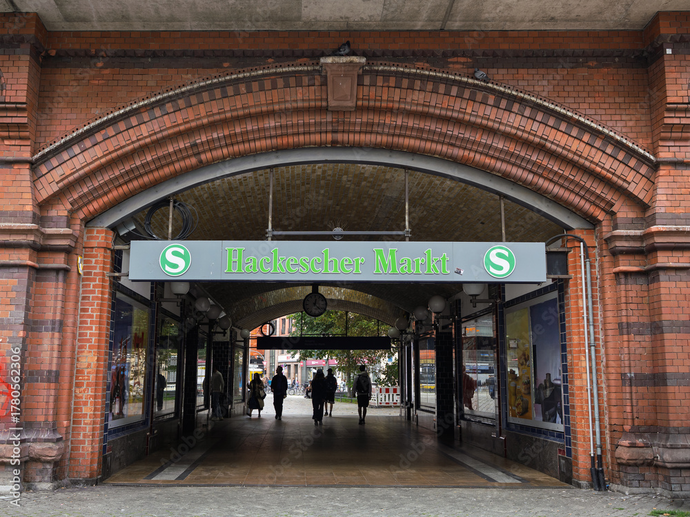 Fototapeta premium Berlin, Germany - august 3 2025: S-Bahn Train Station Tunnel With People In Central Berlin, Historic Red Brick Archway Entrance To Hackescher, Germany