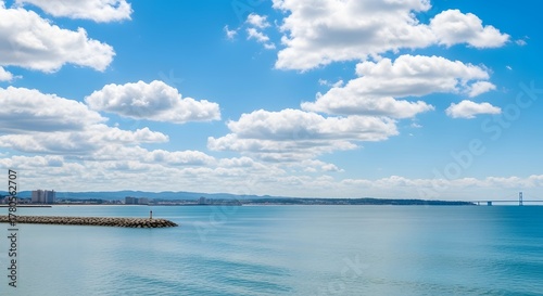 Ocean view with clouds and distant bridge
