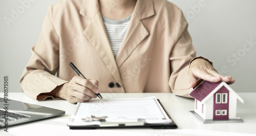 home dealer businessman signing car insurance document or lease paper. home loan and insurance concept