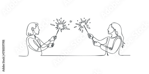 Two women holding sparklers with fireworks