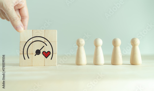 Soft skills and emotional intelligence in business leadership. Wooden blocks with heart and gauge icons, symbolizing soft skills, empathy, emotional intelligence and balanced business performance.