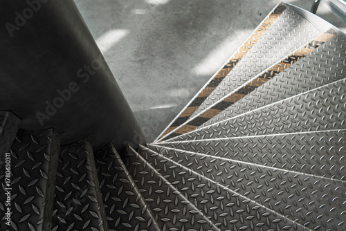 Foto Top view of industrial metal spiral staircase in atrium, strong radial lines and soft daylight patches shape austere composition