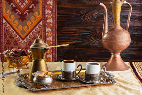 cup of coffee and vintage coffeepot on wooden table