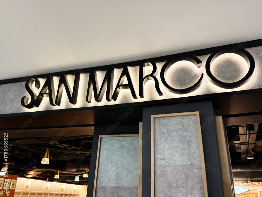 Fototapeta premium San Marco restaurant in Dublin Ireland interior with diners, modern lighting, and stylish signage