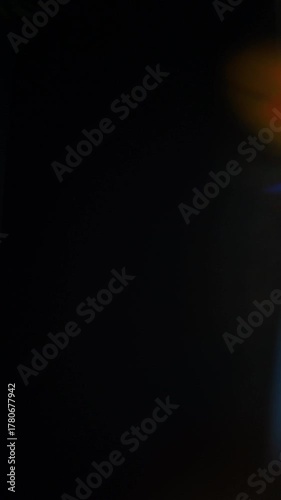 Sun glare, lens flare on a black background for transition to video. Colored rays