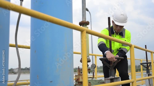Engineer inspecting valves and monitoring system operation at wastewater treatment plant, focusing on clean water purification, recycling, and sustainable industrial water management.