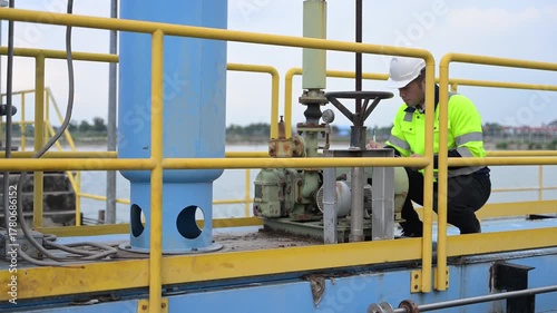 Engineer inspecting valves and monitoring system operation at wastewater treatment plant, focusing on clean water purification, recycling, and sustainable industrial water management.