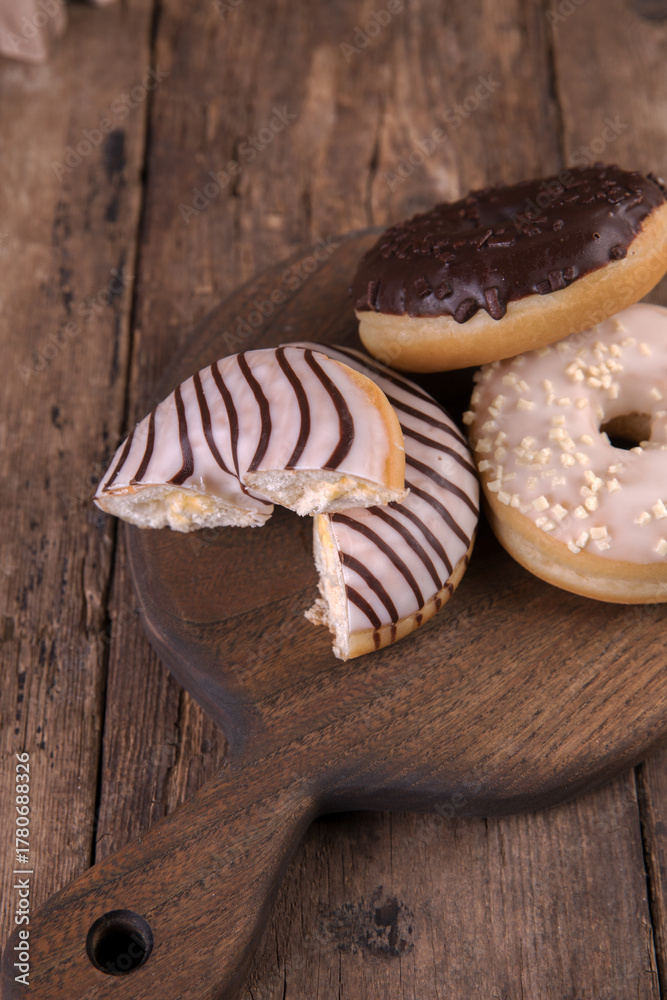Fototapeta premium An assortment of donuts on a wooden background