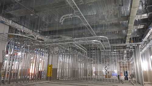 complex network of cable trays and mechanical systems in a commercial building construction ceiling