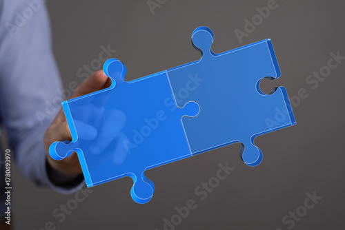 A person's hand holding two...