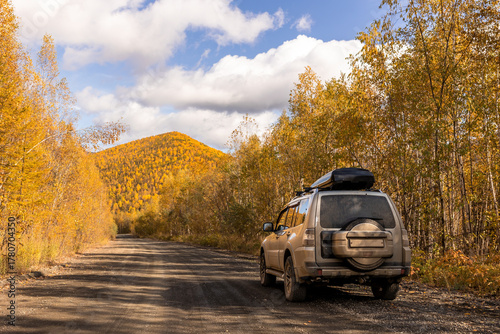 Japanese SUV on scenic autumn road in the forest