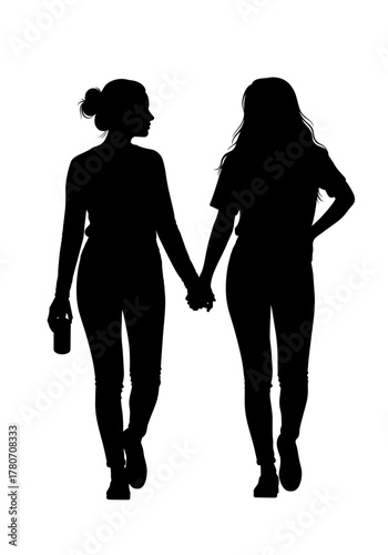 Two women walking together, holding hands in silhouette