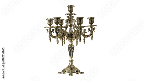 Ornate multi-arm metal candlestick fixture stands against a solid dark background