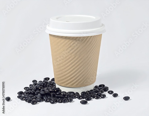 Disposable ripple paper coffee cup with a lid surrounded by coffee beans.