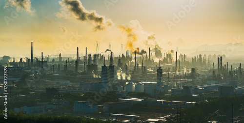 Aerial shot of an oil refinery and chemical plant with smoking chimneys in a large industrial area