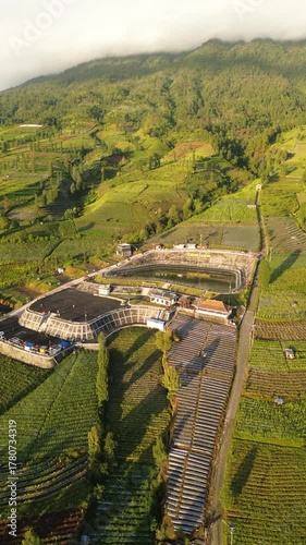 Aerial View Of Terraced Vineyard And Modern Visitor Complex In Mountainous Valley During Golden Hour