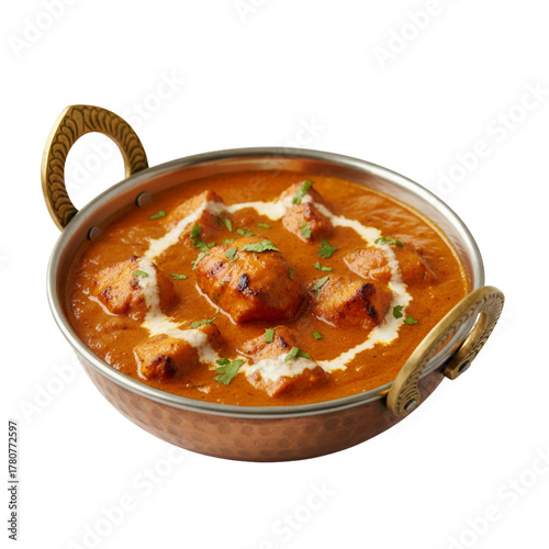 Creamy Indian paneer butter masala curry garnished with cream and coriander served in brass kadai bowl.
